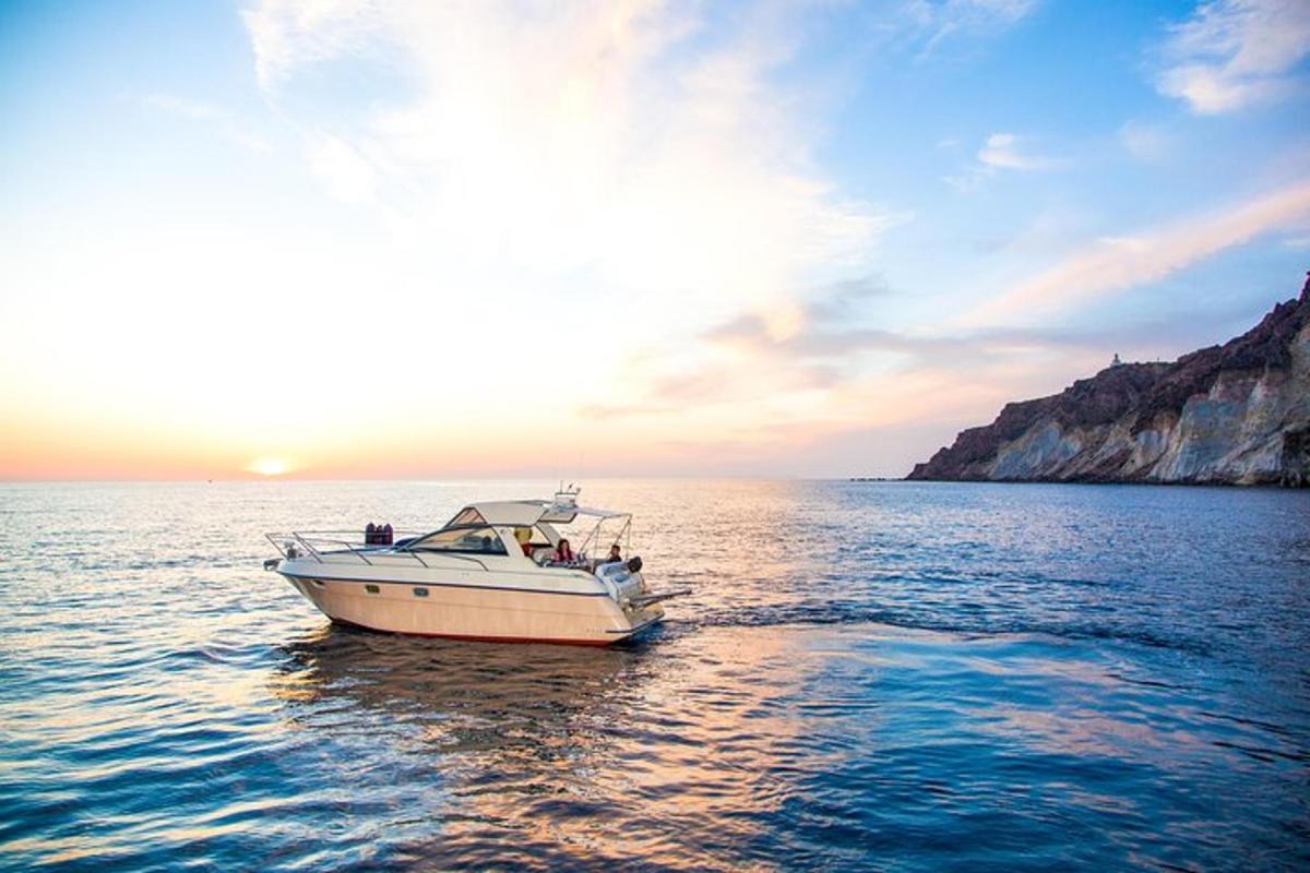 a boat in the water with the sun setting
