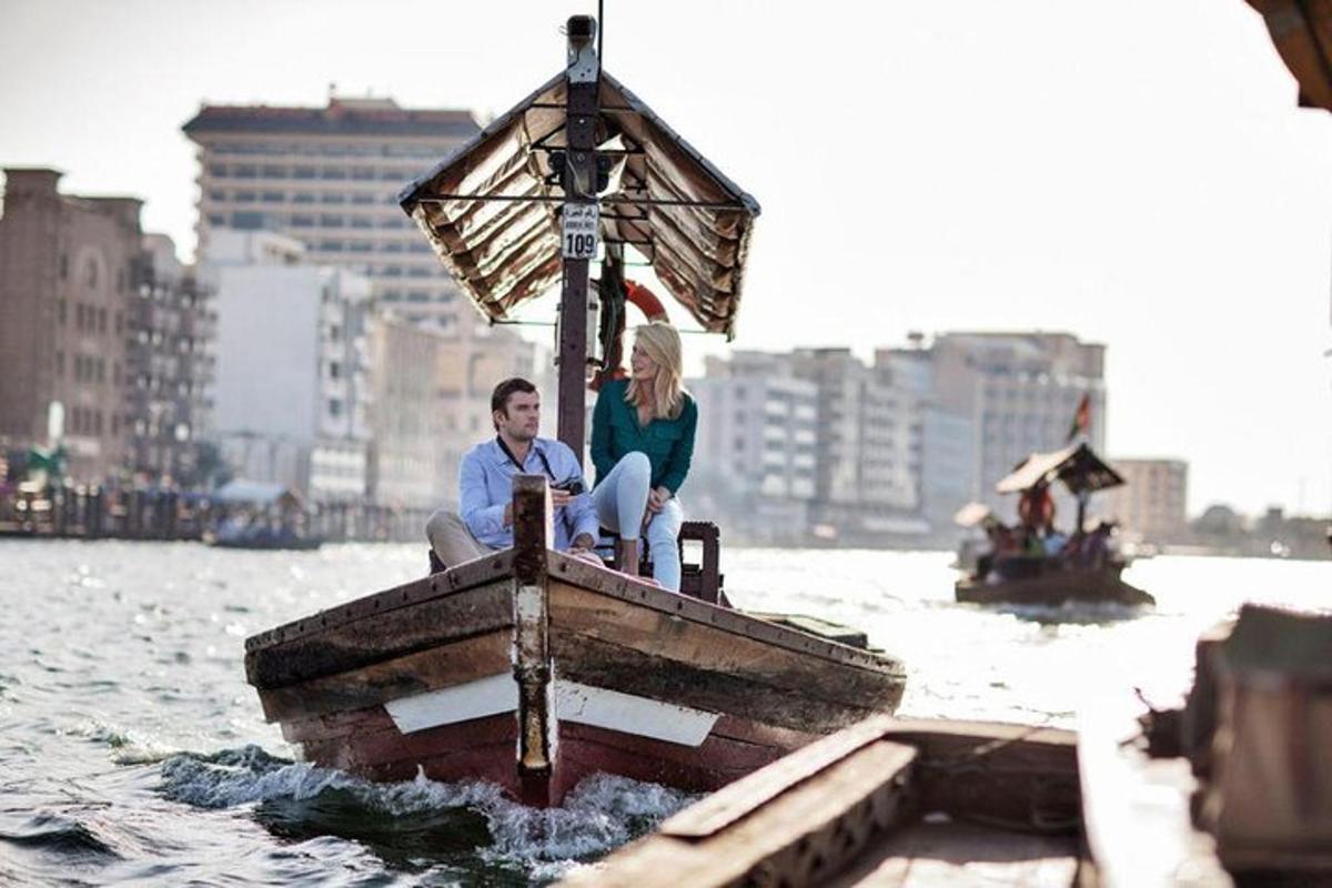 a man and woman sitting on a boat in the water