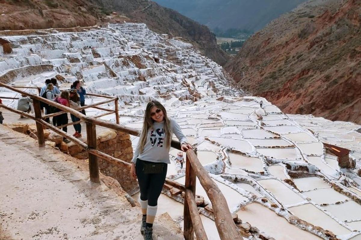 a woman standing on the steps of a snow covered pyramid