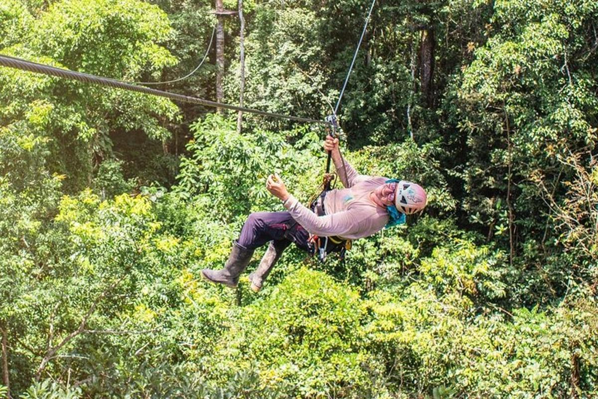 a woman on a zip line in the jungle