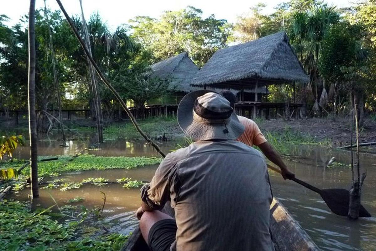 a man is paddling a boat in the water