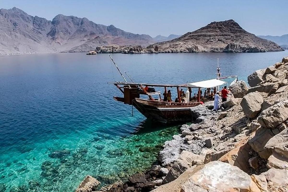 a boat on the shore of a large body of water