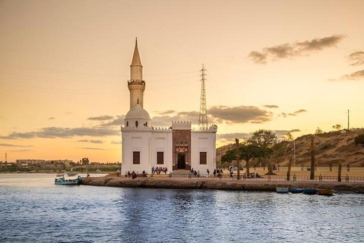 un grande edificio bianco con una torre sull'acqua
