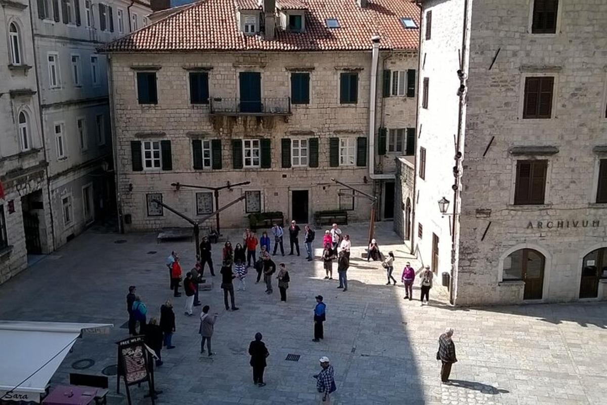 skupina ljudi, ki hodijo po dvorišču stavbe