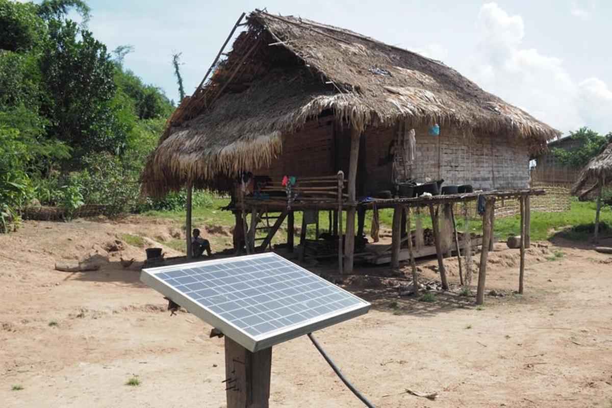 a solar panel sitting in front of a hut