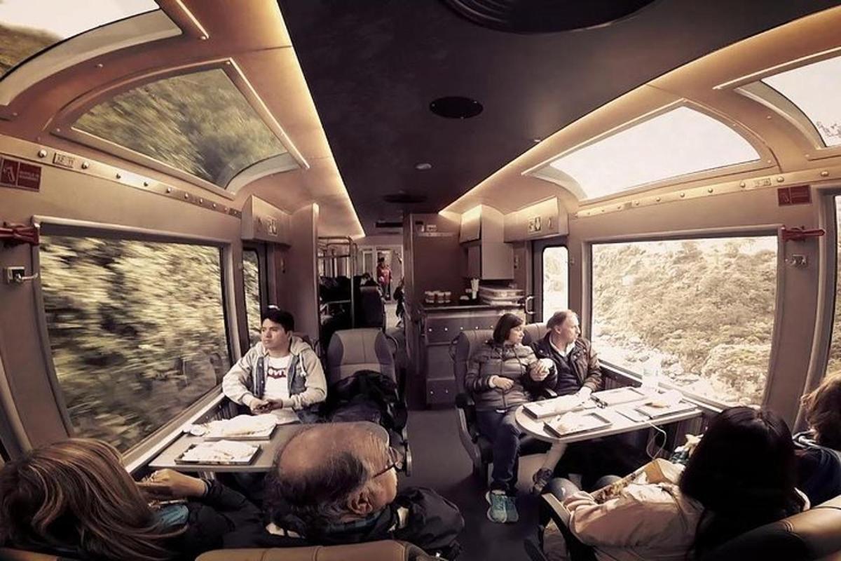 a group of people sitting inside of a train