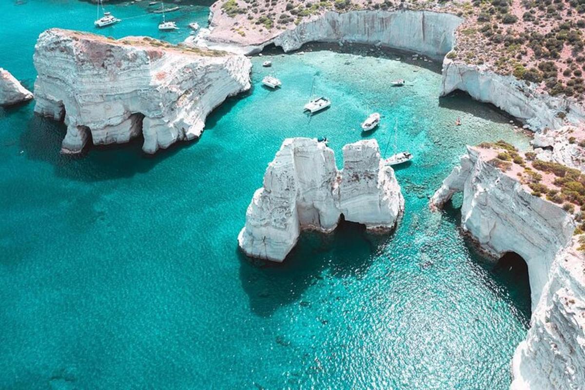 an aerial view of a group of rocks in the water