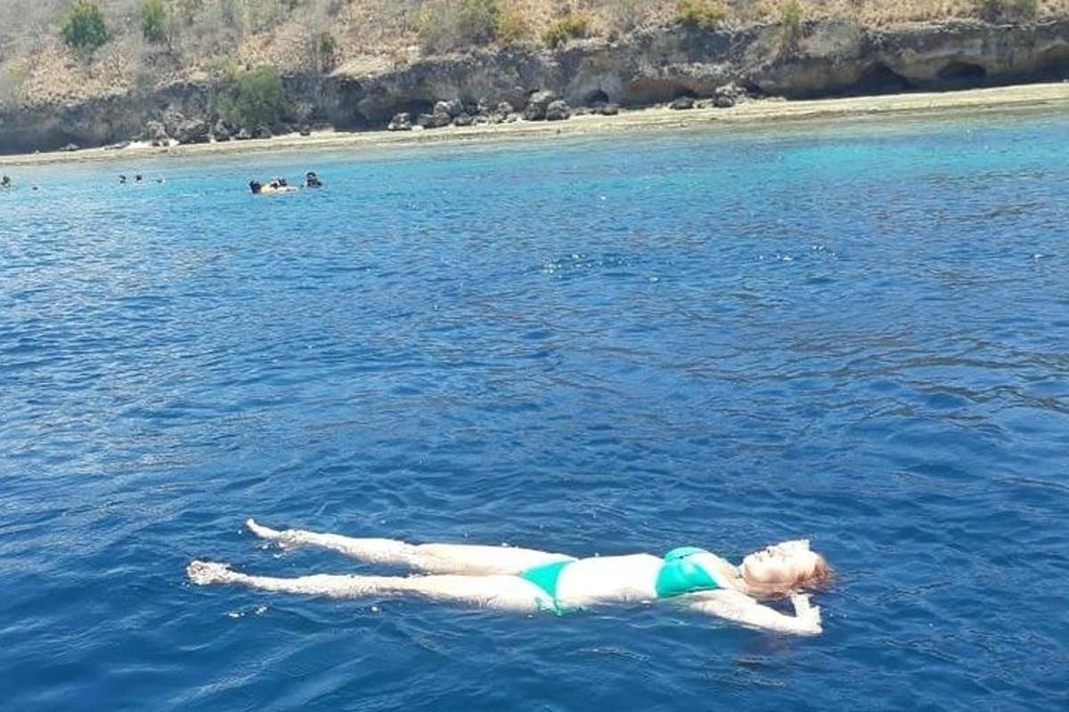 a woman laying on her back in the water