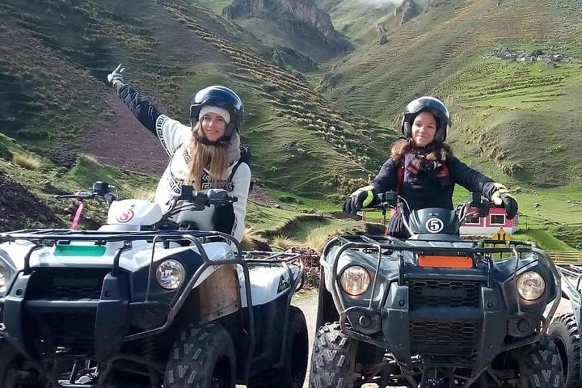 two women riding atvs on the side of a mountain