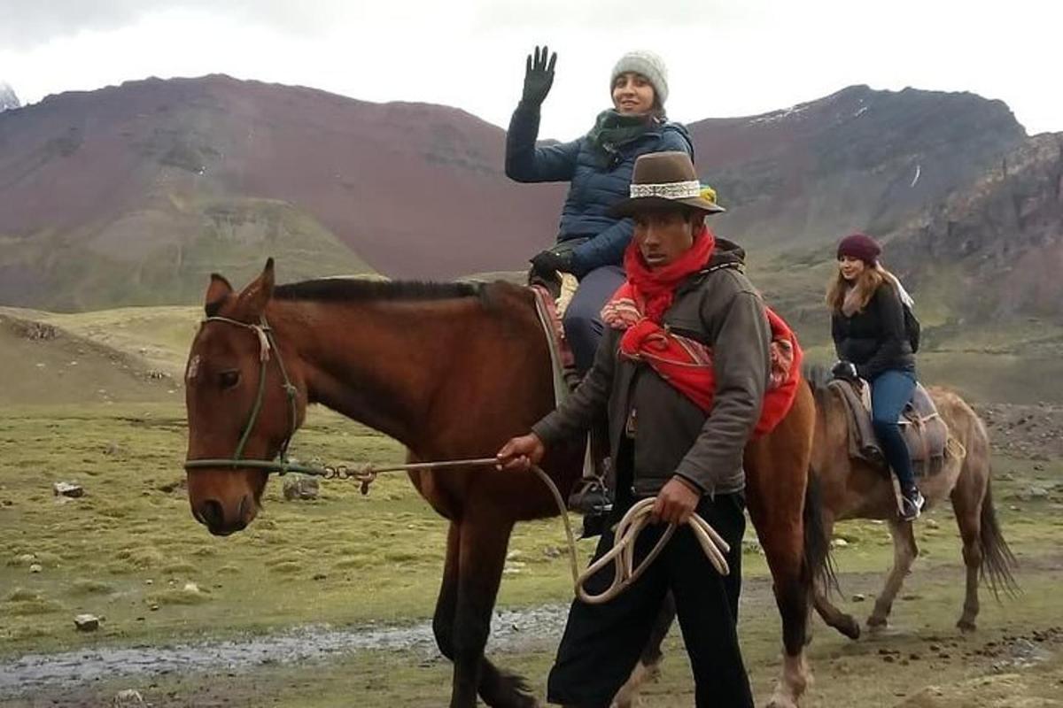 a man and a woman riding a horse with a child on it
