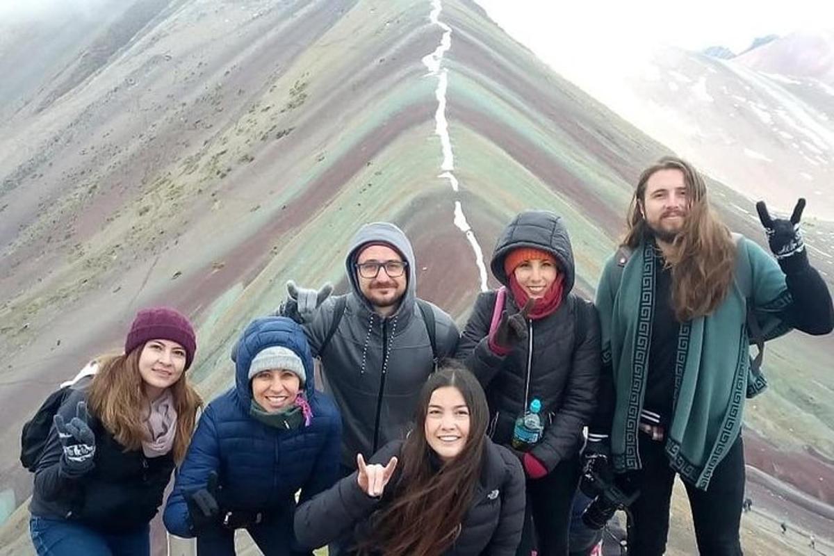 a group of people standing in front of a mountain