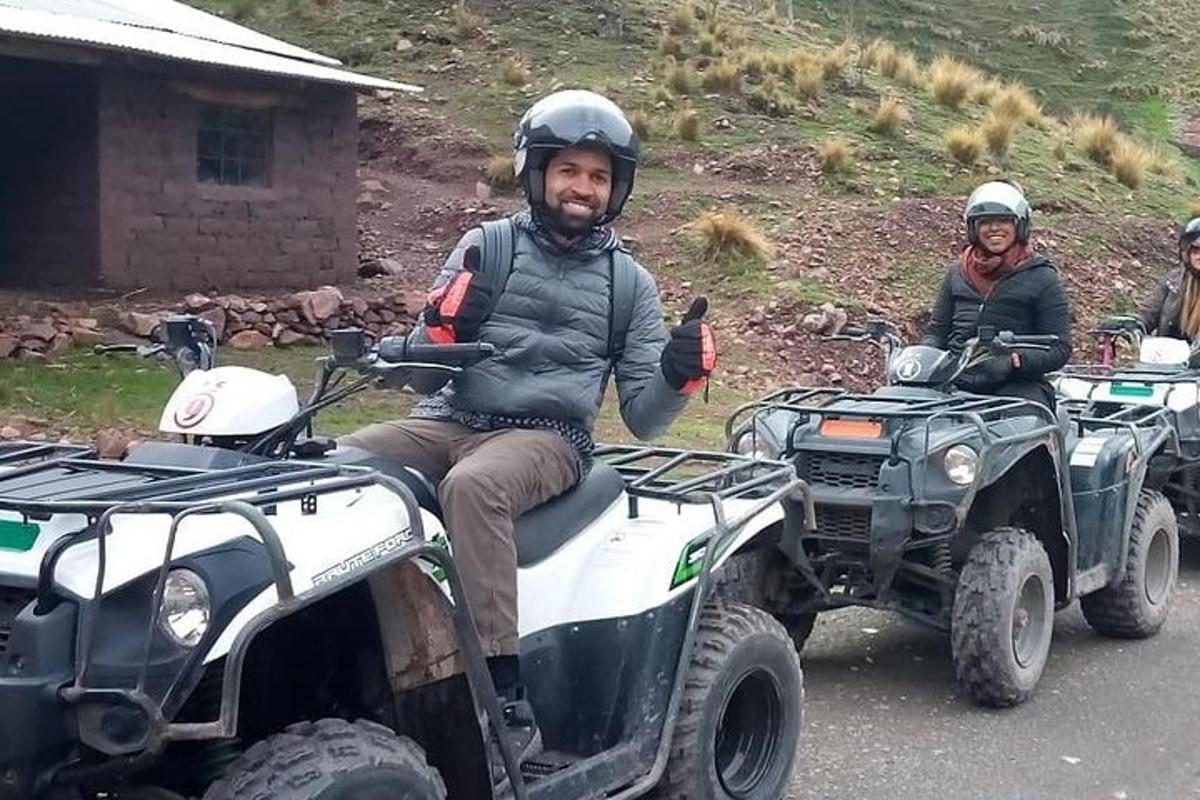 a man and a woman sitting on atvs