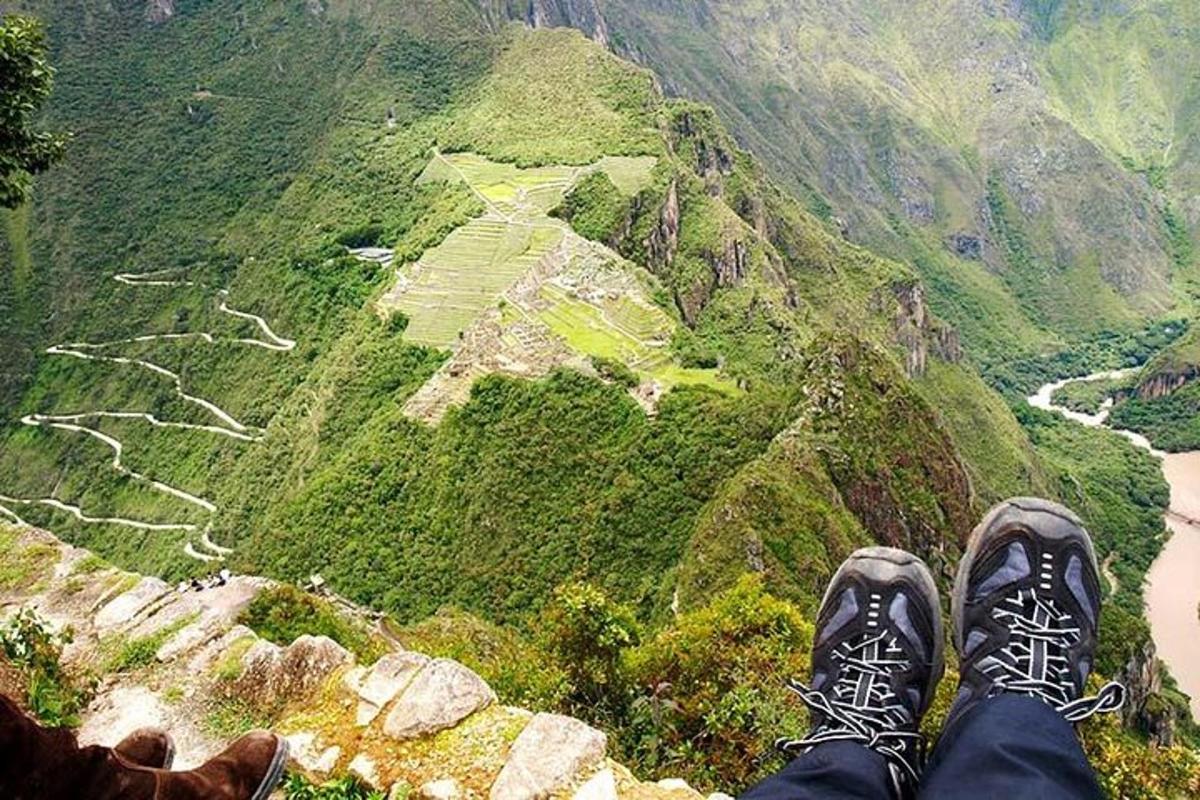 una persona parada en la cima de una montaña mirando un cañón