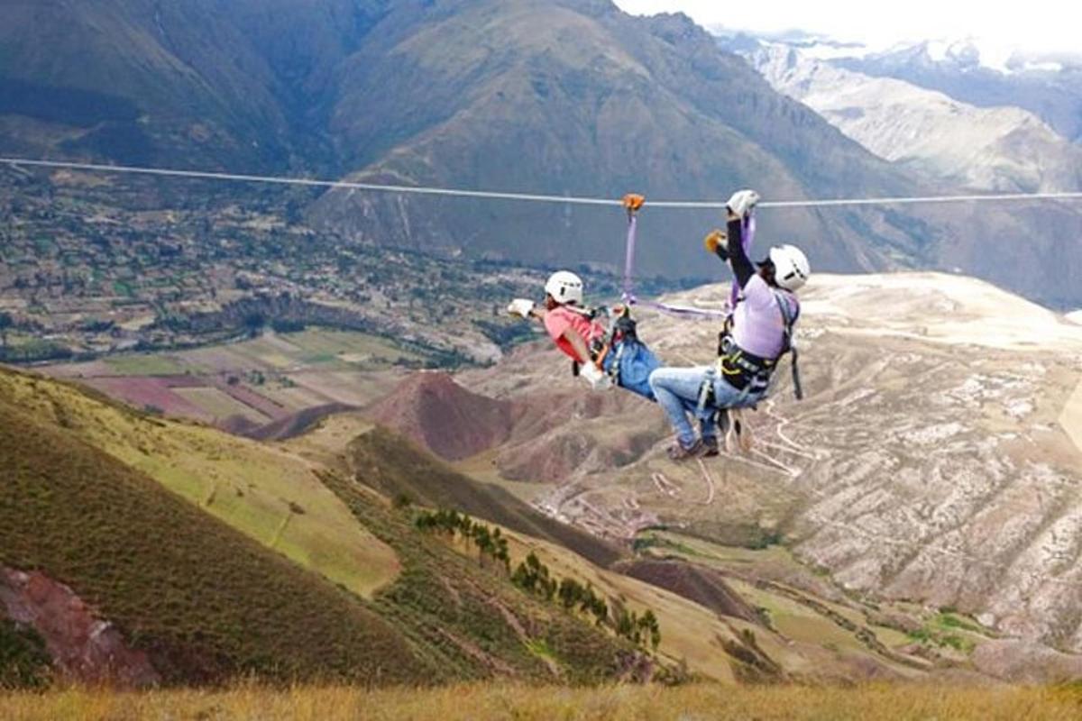 two people are flying in the air over a mountain