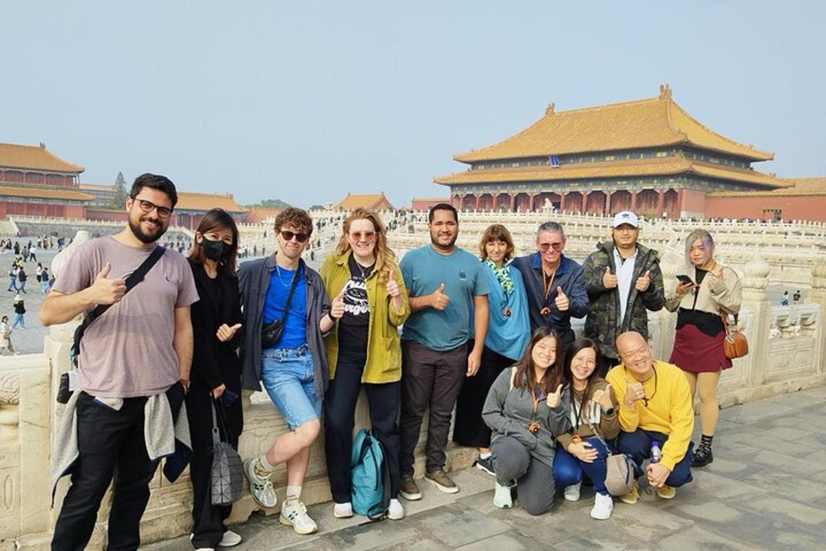 a group of people posing for a picture in front of a building