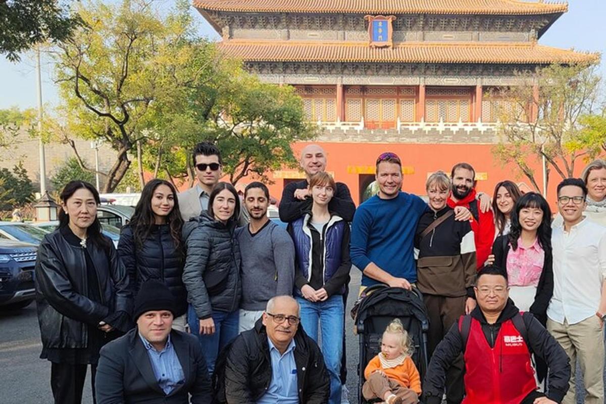 a group of people posing for a picture in front of a building
