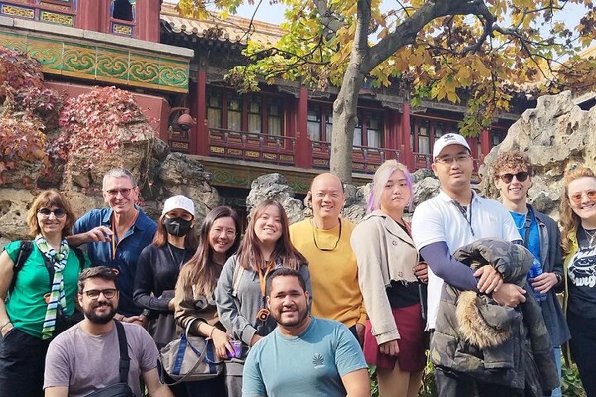 a group of people posing for a picture in front of a building