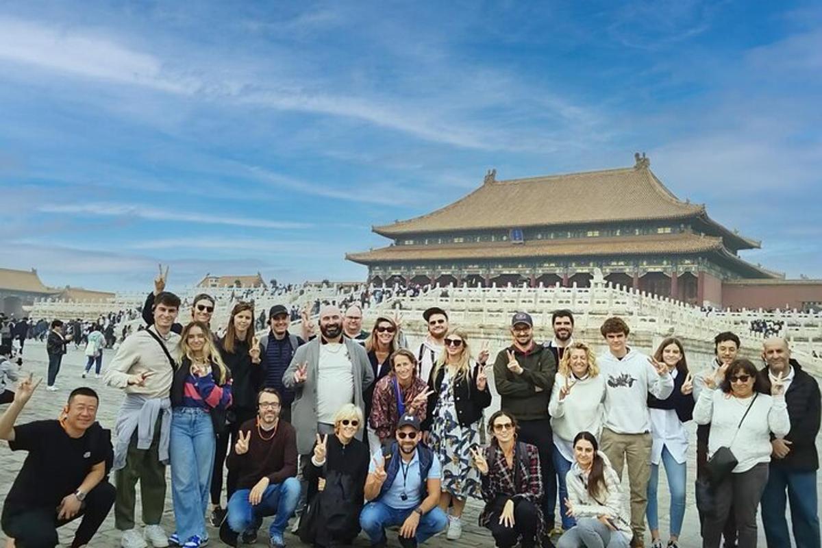a group of people posing for a picture in front of a building