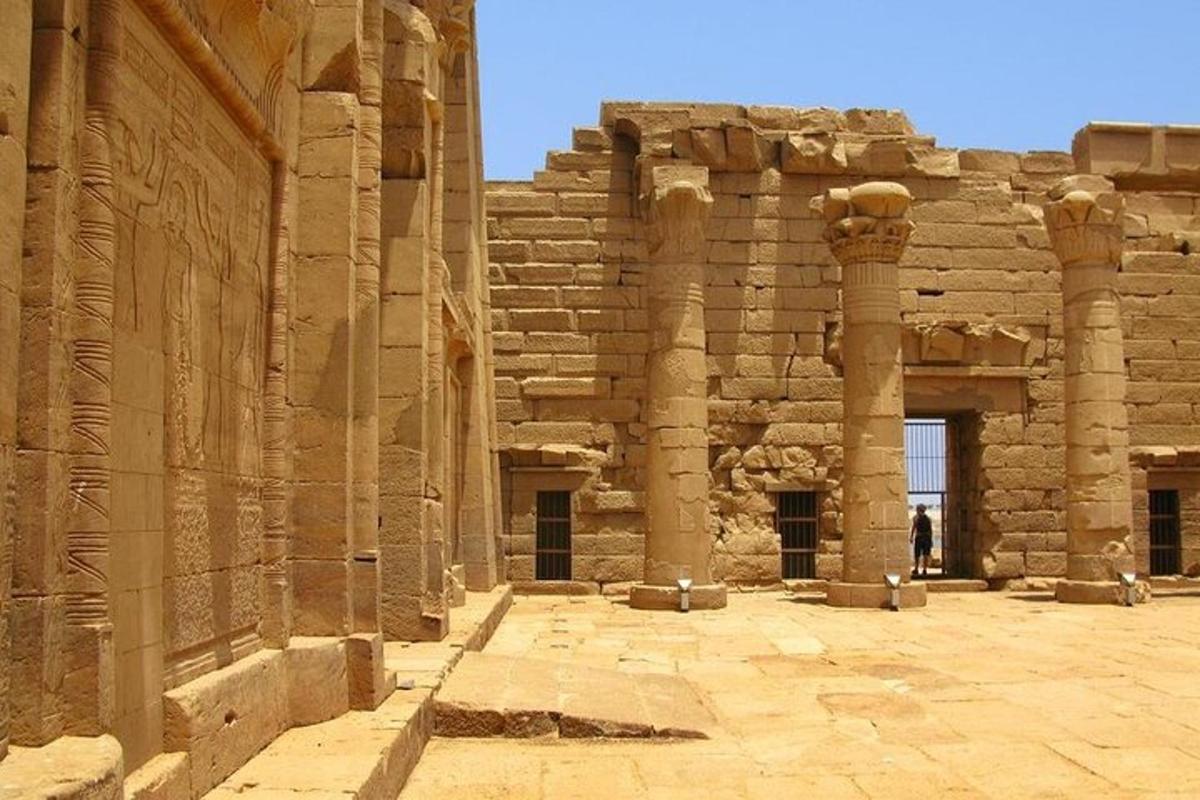 a building with columns and a person standing in front of it