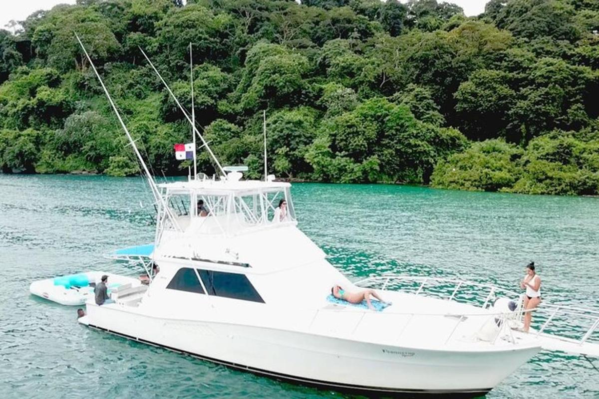 a white boat in the water with people on it