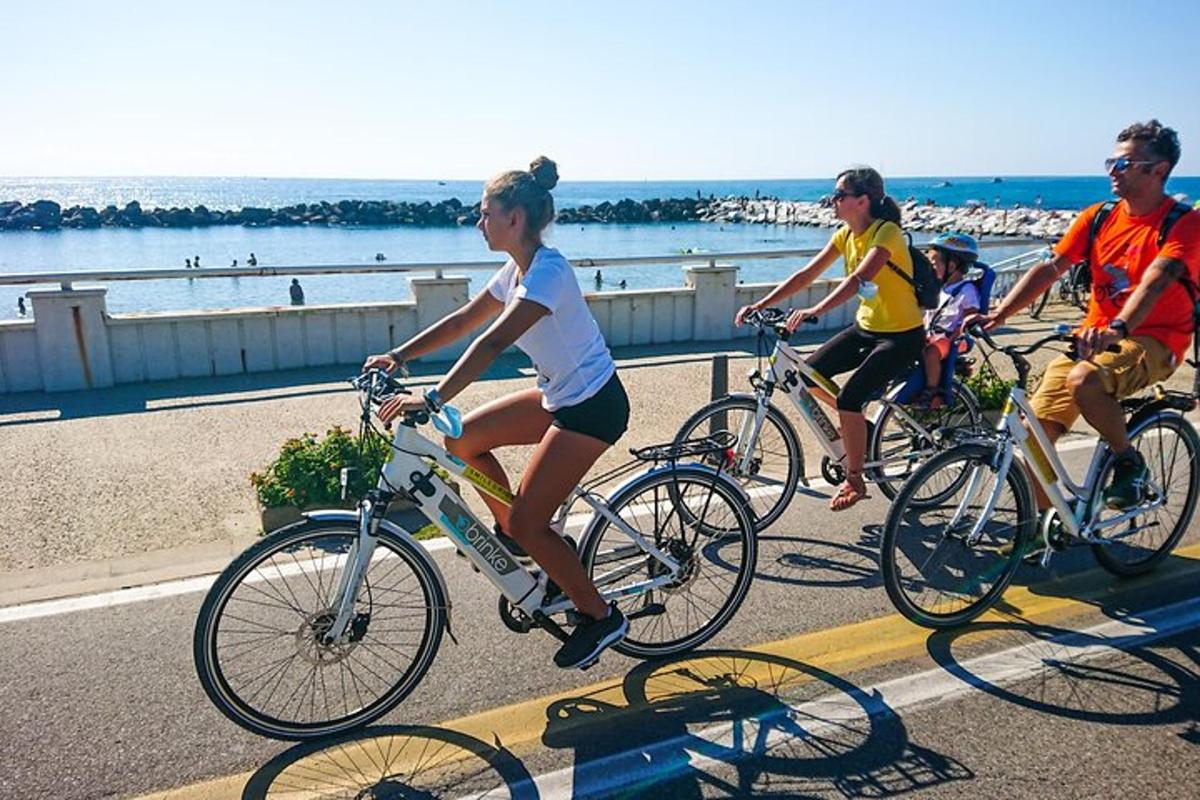 a group of people riding bikes on the beach
