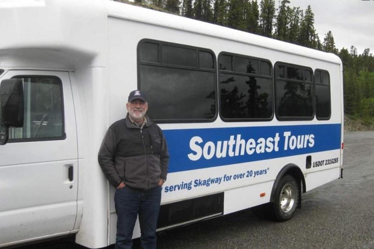 a man is standing in front of a bus