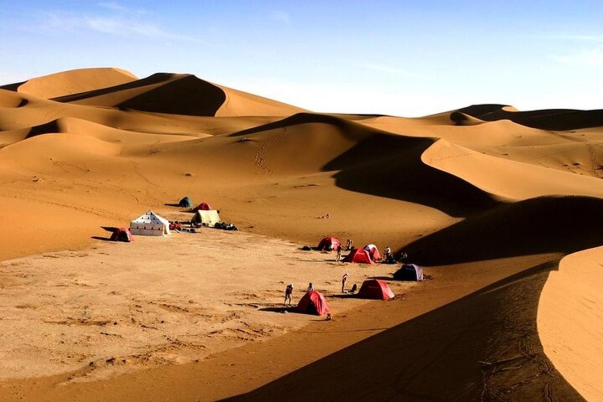 a group of tents in the sand in the desert