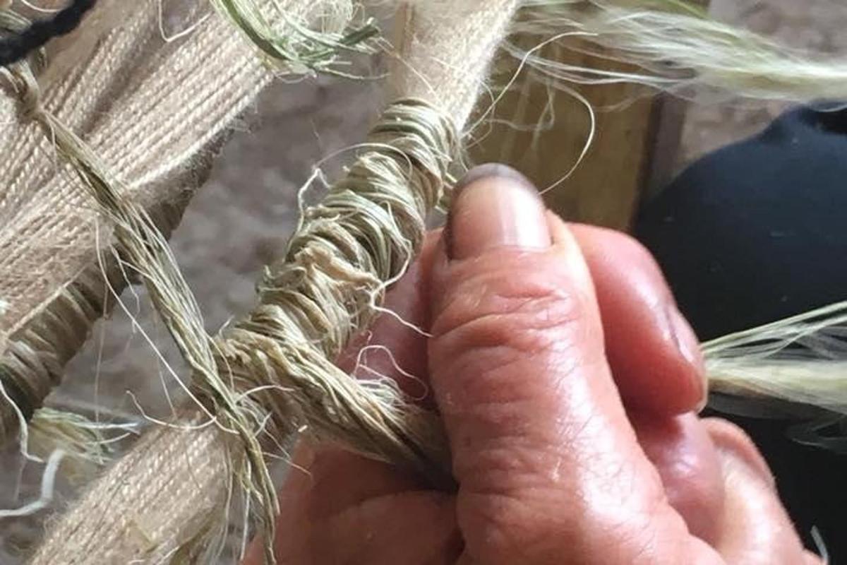 a hand is holding a piece of rope