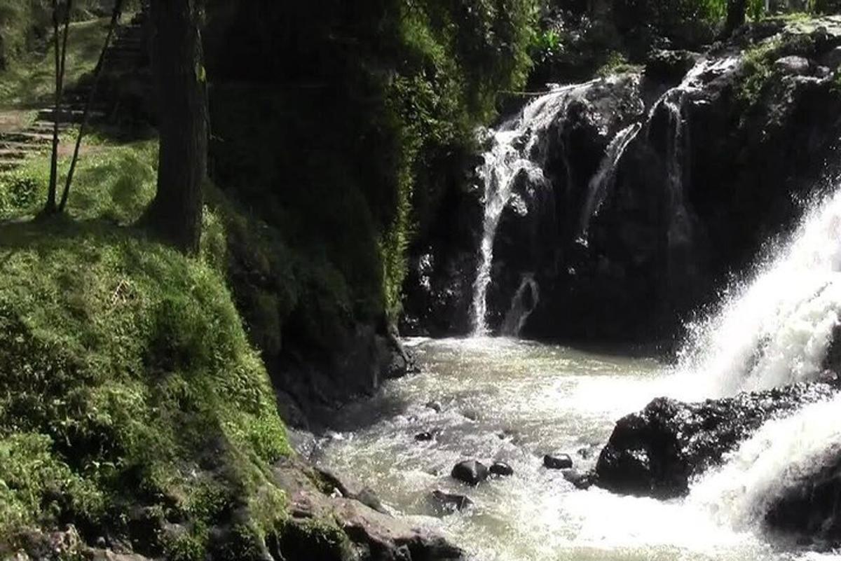 a waterfall in the middle of a river