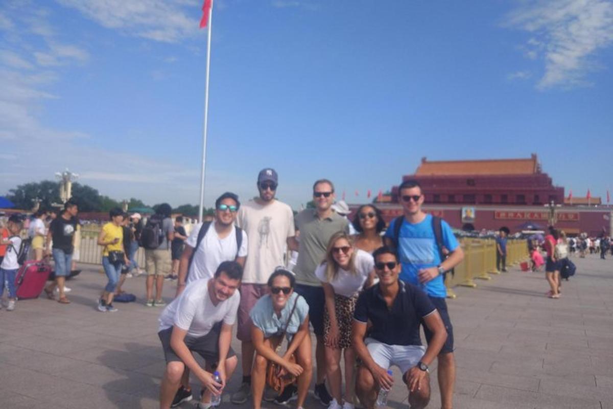 a group of people posing for a picture on a sidewalk