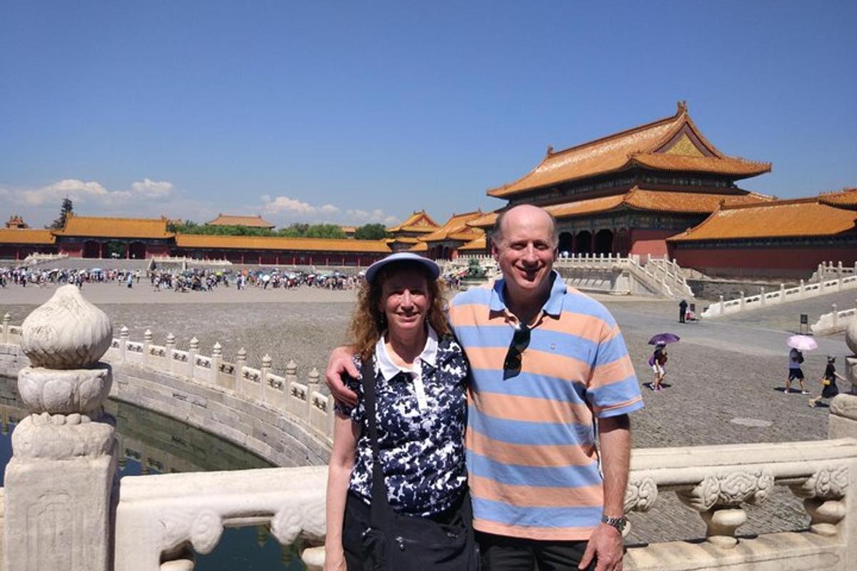 a man and a woman standing in front of a fountain