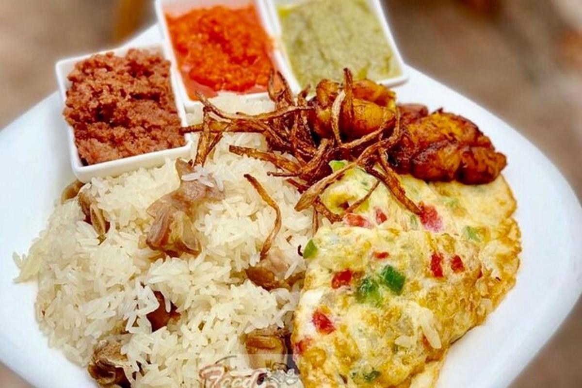 a white plate of food with rice and meat