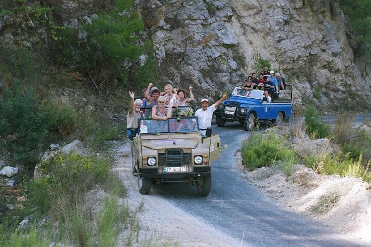 a group of people riding in the back of a jeep