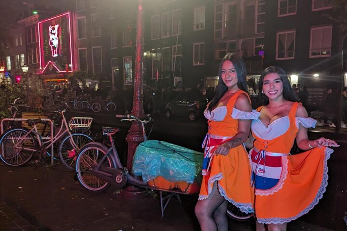 kaks oranžides kleitides naist poseerivad pildi jaoks