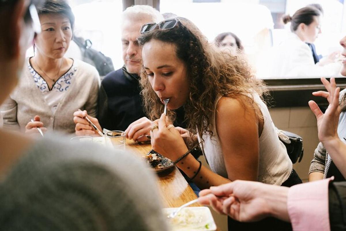 a group of people sitting around a table eating food