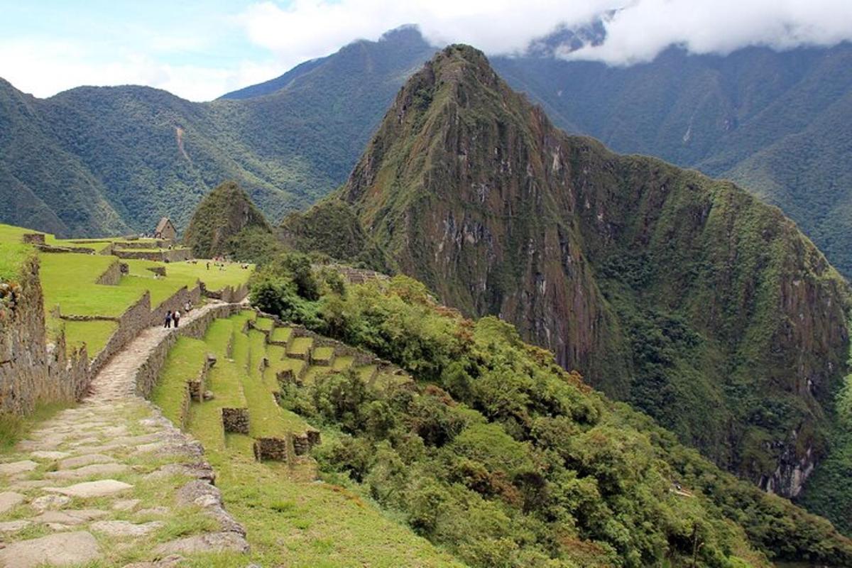 uma vista de uma montanha com pessoas subindo uma colina