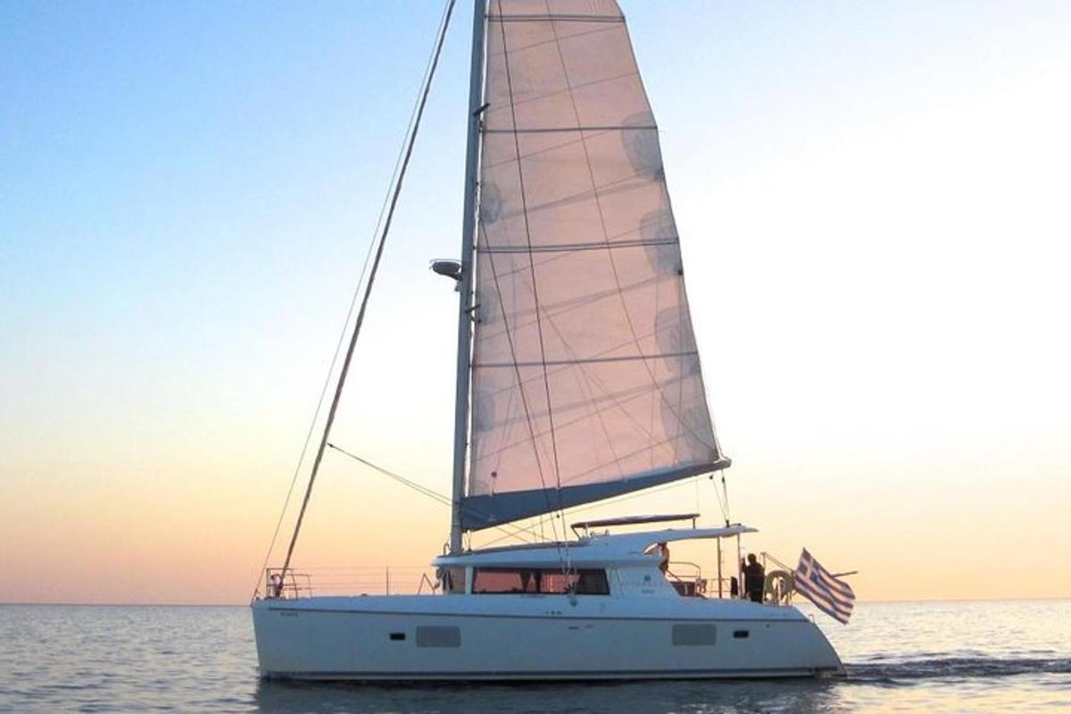 a sail boat in the water with an american flag
