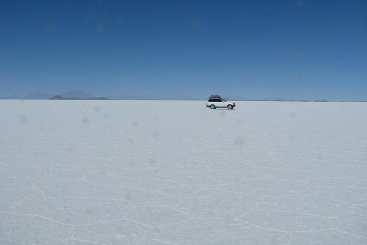 a car driving across a snow covered field