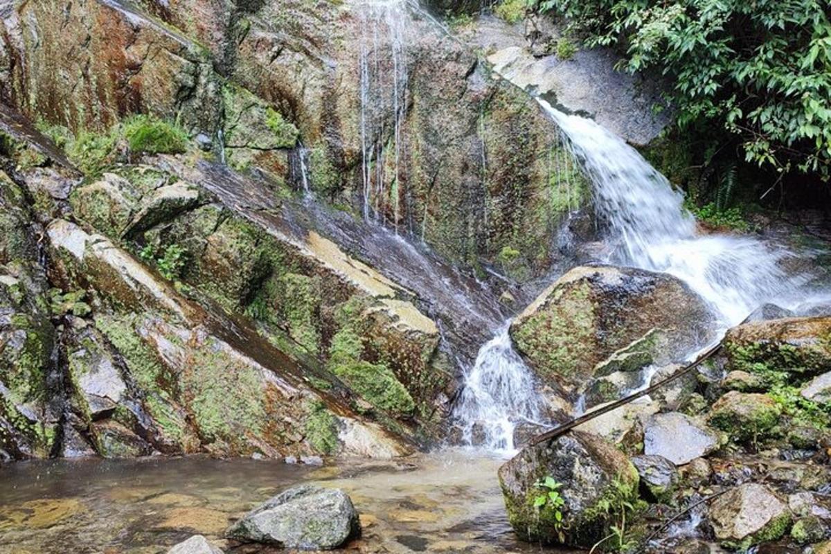 a waterfall on the side of a rock wall