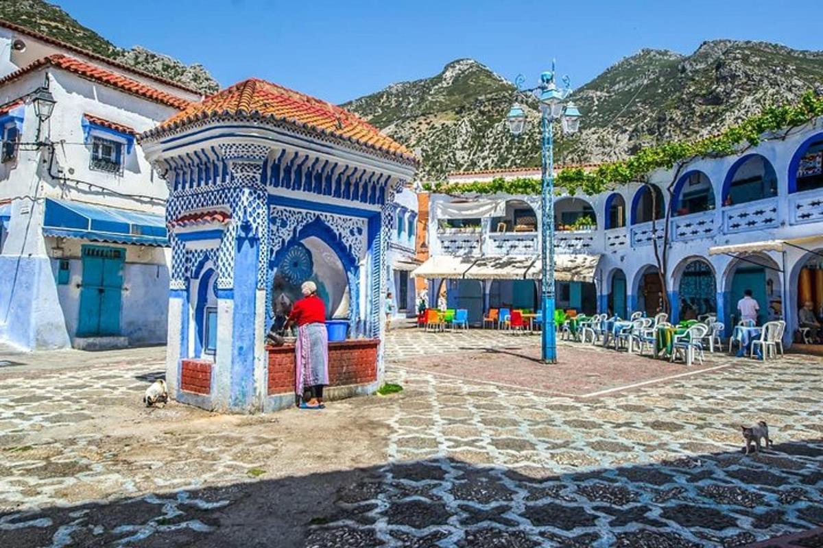 a man standing in a blue and white structure in a courtyard