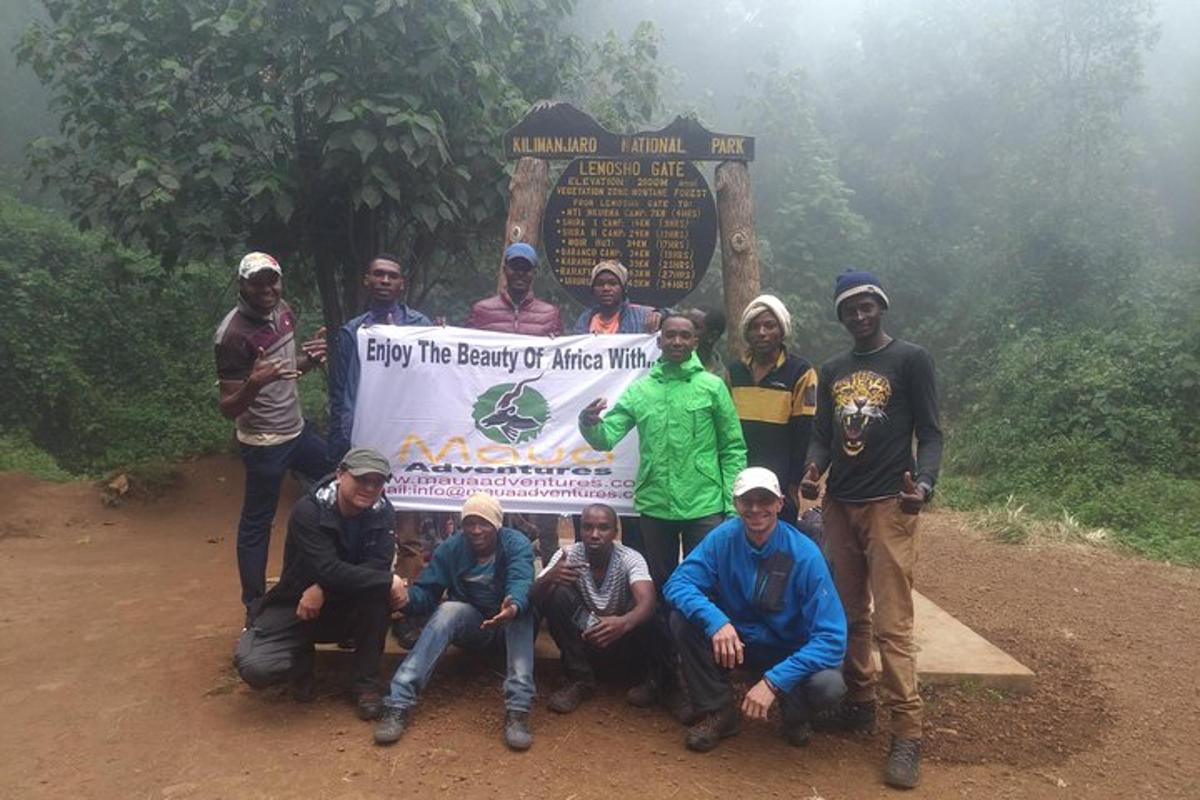 a group of people standing in front of a sign