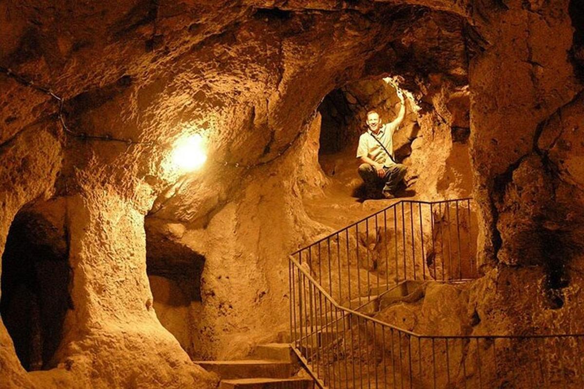 a man sitting on a staircase in a cave