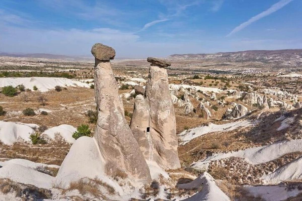 a group of three stone pillars in a snowy field