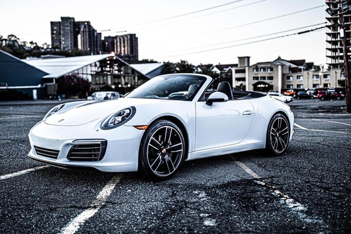a white sports car parked in a parking lot