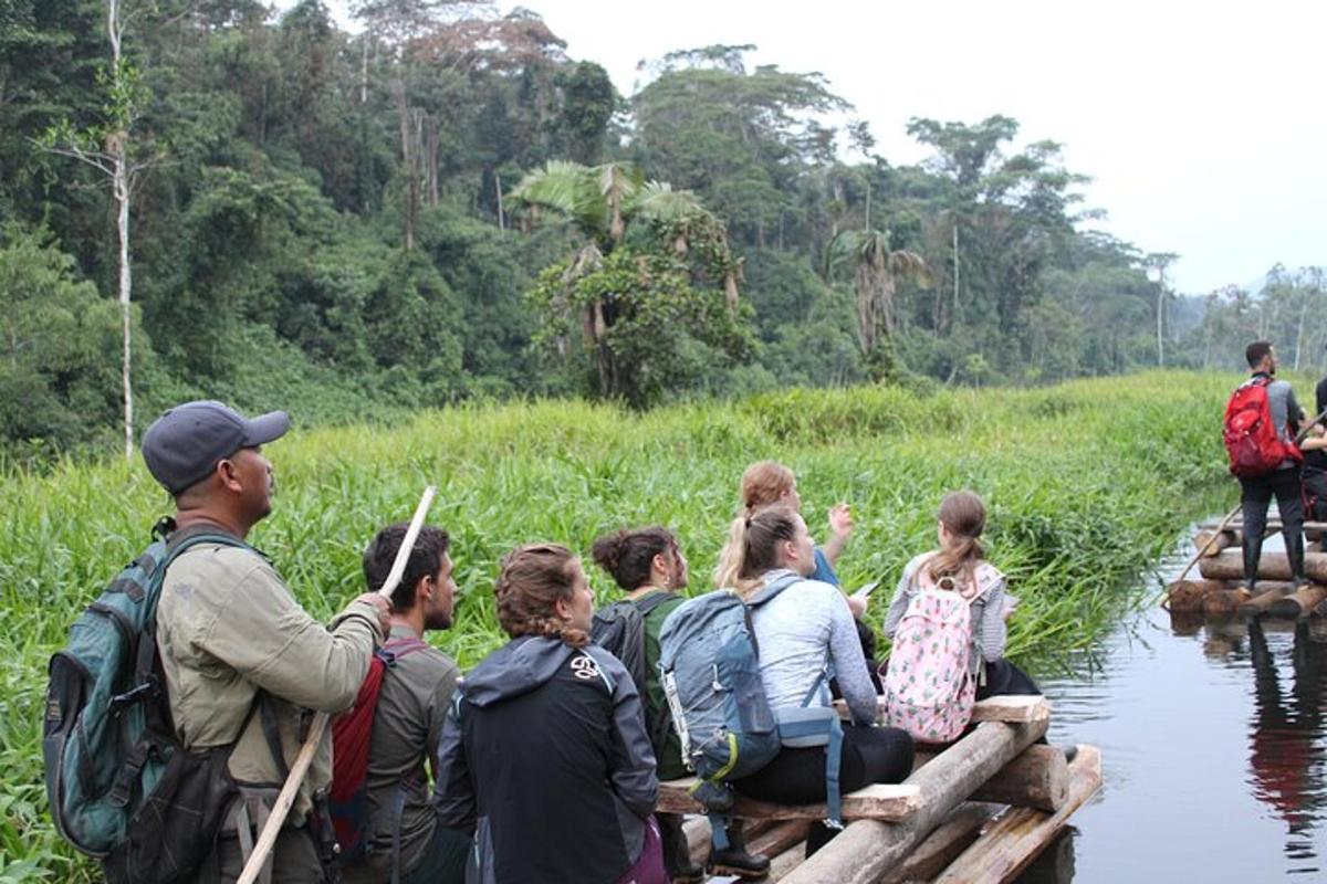 a group of people crossing a river on a raft