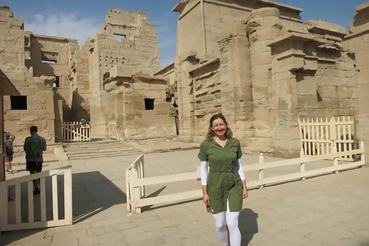 a woman is standing in front of a building