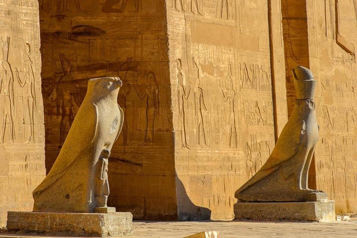 two statues are sitting in front of a building