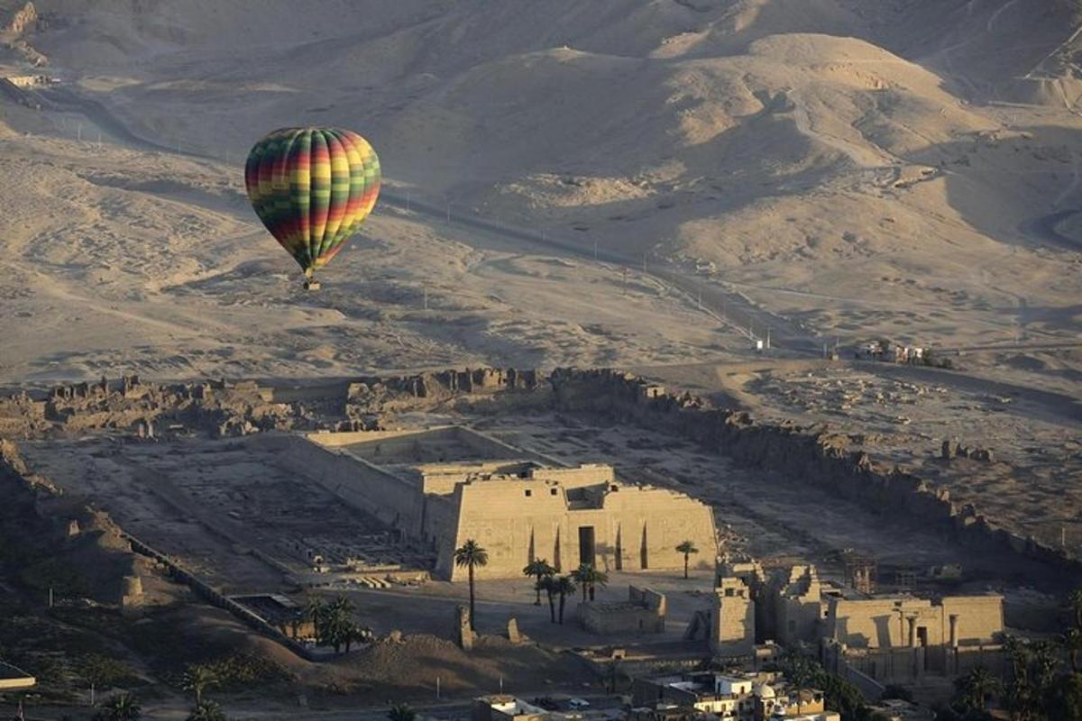 a hot air balloon is flying over a city