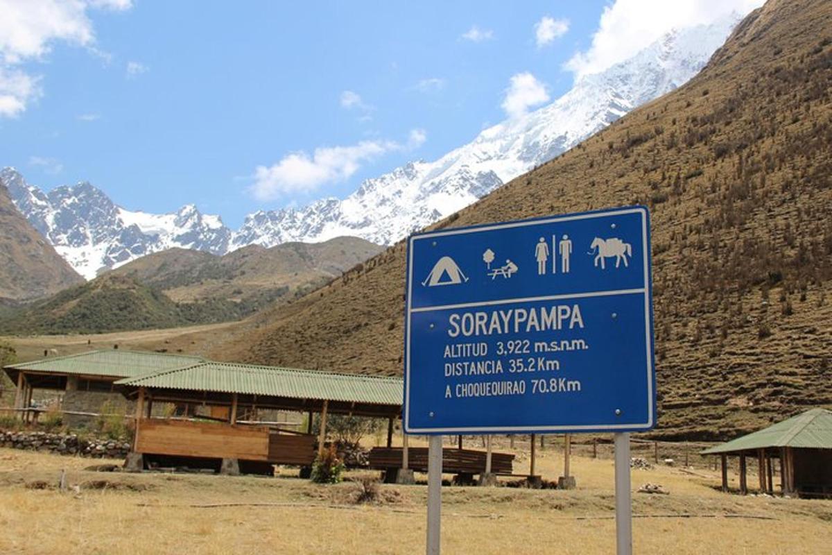 un cartel azul delante de una montaña