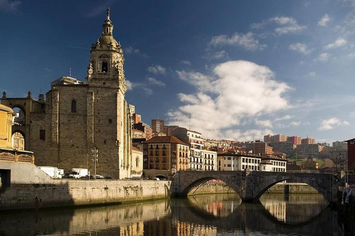 a bridge over a river with a building and a clock tower